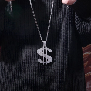 Detail of hip hop silver dollar sign pendant necklace with iced out cubic zirconia
