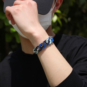 Detailed view of men's hip hop chain bracelet with blue enamel geometric patterns