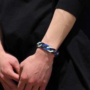 Close-up of hip-hop men's Cuban chain bracelet with blue enamel geometric links