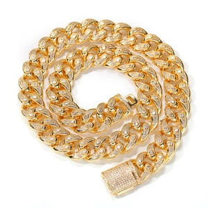 Close-up of 15mm gold Cuban link chain featuring pear-cut zircon stones and iced out clasp