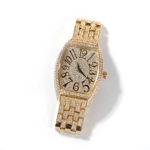 Macro detail of the iced-out gold tonneau watch showing full crystal pavé and black numerals