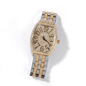 Macro detail of luxury iced-out tonneau watch face with diamonds and Arabic numerals