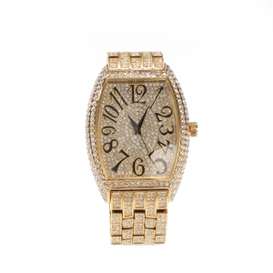 Luxurious gold tonneau watch for men with iced out crystals and large numerals