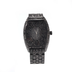 Close-up of black tonneau iced out watch with full diamond setting and large numerals