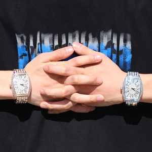 Detailed macro view of iced-out tonneau watches in silver and rose gold finishes