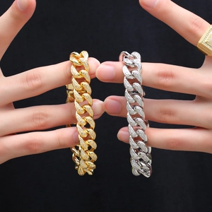 Close-up of 15mm gold and silver Cuban link bracelets with micro-pave cubic zirconia