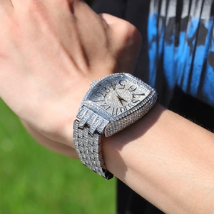 Macro shot of luxury tonneau diamond watch with iced out dial and pave-set metal band