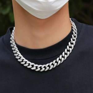 Close-up of 15mm silver Cuban link necklace with micro-pave cubic zirconia on male model