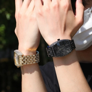 Luxurious iced-out tonneau watches with full crystal pavé in gold and black finishes