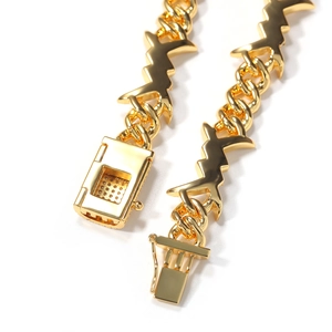 Detailed close-up of golden Cuban chain link with geometric lightning bolt accents