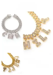 Detail of hip-hop Cuban link chain with baguette-cut diamond letter pendants