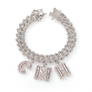 Detail of silver Cuban link chain with baguette-cut diamond C, M, H letter pendants