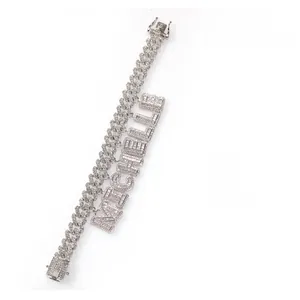 Close-up of iced out Cuban link chain with custom Michelle letter pendant inlay
