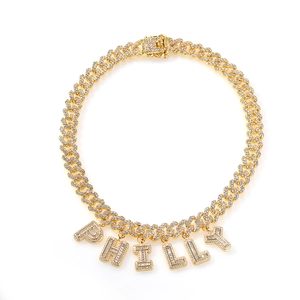 Close-up of golden Cuban link necklace with crystal-encrusted letters PHILLY in hip-hop style