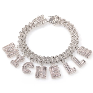 Silver Cuban link bracelet featuring iced-out MICHELLE letter pendants with box clasp