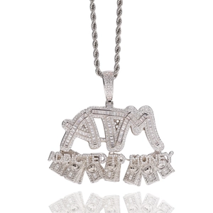 Macro detail of ATM dollar pendant with cubic zirconia and silver twisted rope chain
