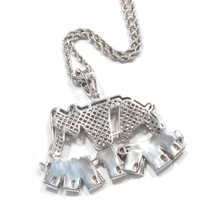 Macro detail of elephant pendant with mother-of-pearl base and silver rope chain