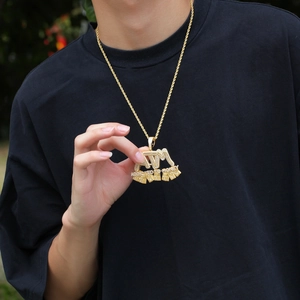 Detailed close-up of iced out ATM pendant necklace with sparkling cubic zirconia crystals