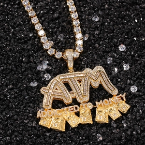 Macro shot of gold ATM pendant with ADDICTED TO MONEY text and iced out tennis chain