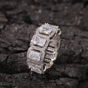 Macro detail of silver ring with large rectangular zircons and surrounding accent stones