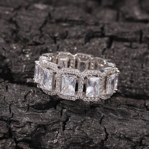 Macro detail of silver ring featuring emerald cut stones and micro-pave crystals