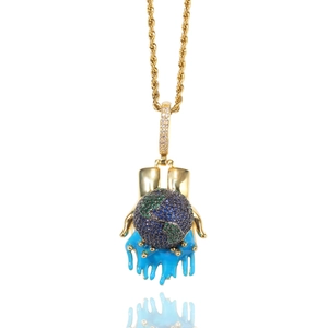 Close-up of hip-hop earth pendant with blue melting oil drip and gold rope chain