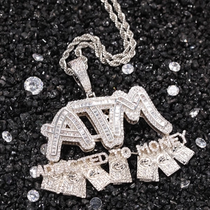 Macro shot of silver ATM Money pendant with baguette and round cut cubic zirconia stones