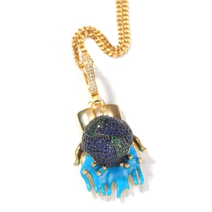 Detail of hip hop globe pendant with blue dripping enamel and gold cuban chain link
