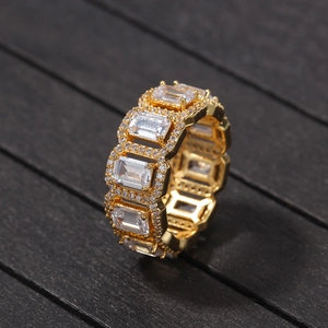 Macro view of gold eternity ring with rectangular zircons and pave set stones