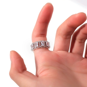 Macro detail of silver-tone ring featuring hollow rectangular zircon stones and pavé setting