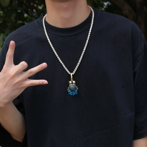Hip hop tennis chain with blue oil-dripping globe pendant on a black t-shirt