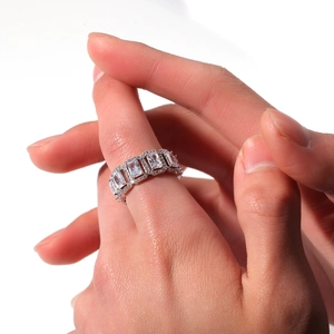 Macro shot of rectangular zircon stones set in a silver ring on a model's hand