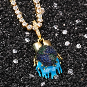 Close-up of hip hop iced out globe pendant with blue drip on a tennis chain