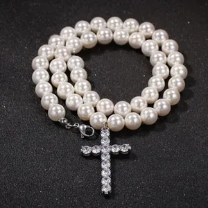 Close-up of hip hop pearl necklace featuring a zircon encrusted cross pendant
