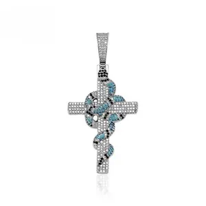 Macro shot of silver gothic snake pendant wrapped around a stone studded cross