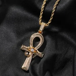 Macro shot of gold-plated Ankh cross pendant with Eye of Horus and pavé cubic zirconia