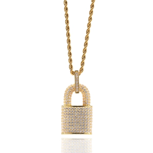 Macro shot of gold hip hop lock pendant with sparkling zircon stones and rope chain