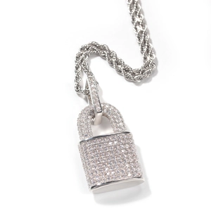Detailed close-up of iced-out padlock pendant necklace with shimmering zircon stones