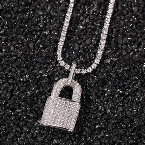 Macro detail of silver hip hop padlock pendant with pave cubic zirconia on tennis chain