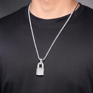 Detail shot of iced out silver padlock pendant on a tennis chain with white zircons