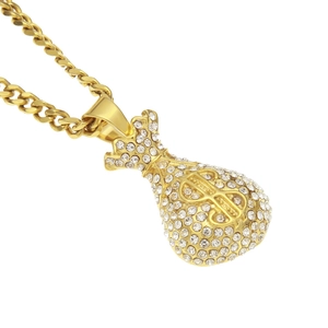 Macro detail of gold money bag pendant with crystals and dollar sign on cuban chain