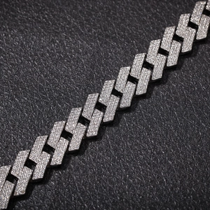 Detail of silver Cuban chain with triple-row iced out rhinestones on black leather