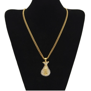 Detail of gold-plated cuban chain with dollar sign money bag pendant encrusted with rhinestones