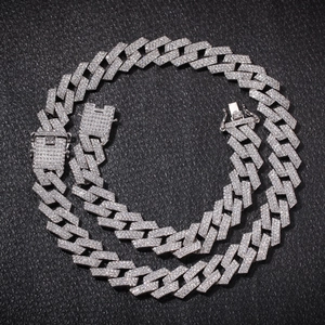 Macro detail of silver-plated iced out Cuban link chain with secure box clasp