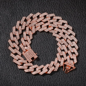 Close-up of triple-row iced out Cuban link chain in rose gold finish with square buckle clasp
