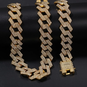 Detailed view of heavy gold-tone Cuban link chain with three rows of sparkling crystals