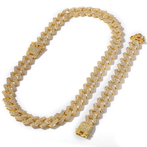 Close-up of golden iced out Cuban link necklace and bracelet set with CZ diamonds