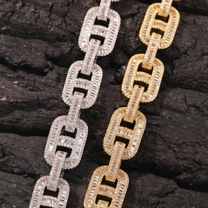 Close-up of 15mm gold and silver iced out pig nose chain necklaces with baguette cubic zirconia