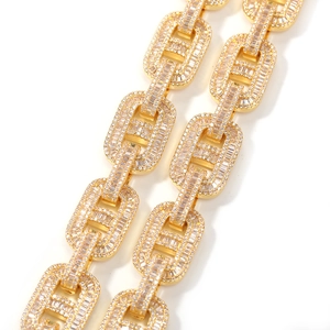 Macro shot of gold hip-hop link chain with baguette and round cubic zirconia inlays