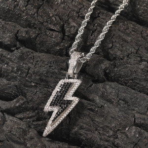 Macro shot of hip-hop lightning bolt pendant with sparkling zircons on black wood